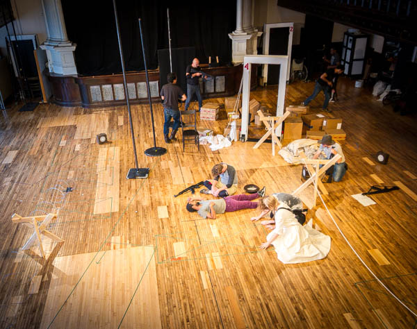 The cast rehearses a war scene